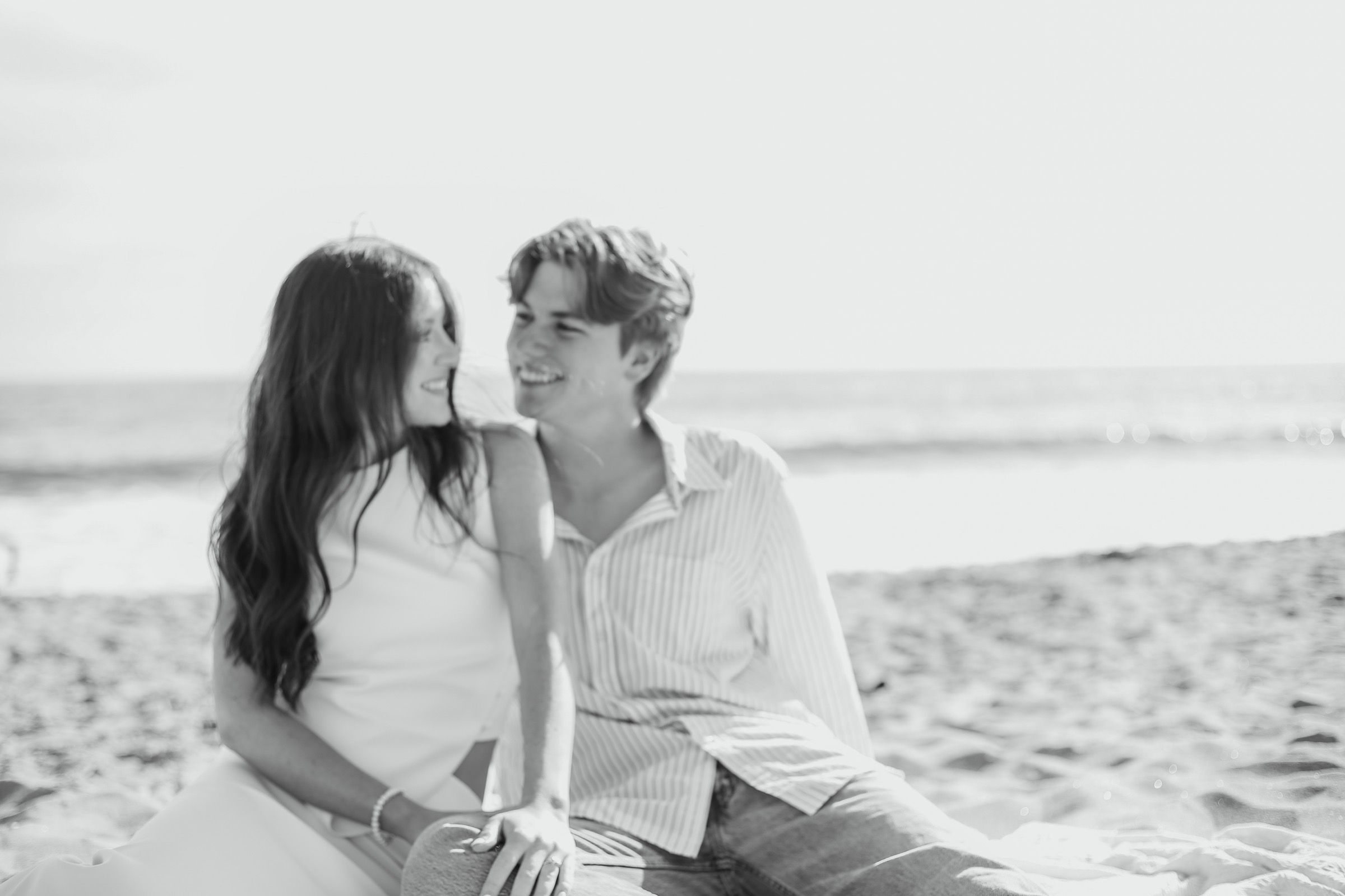 Bridget and Cole sitting together on the beach